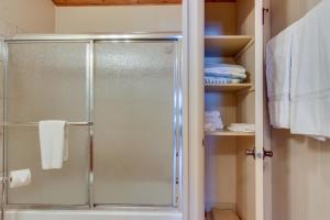 a shower with a glass door in a bathroom at Bay Point Lakefront 1B Up in Whitefish +12 photos