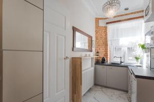 a kitchen with a white door and a brick wall at Crystal Apartament in Lublin