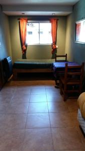 a room with a window and a large tile floor at La Estacion Hostel in Lago Puelo