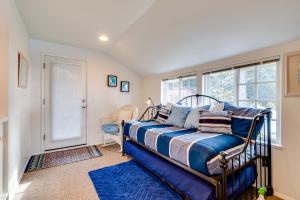 a bedroom with a bed and a window at Hale Kaalawai in Oceanside