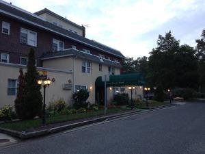 a building on a street in front of a building at Jones Beach Hotel in Wantagh