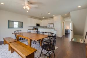 a dining room and kitchen with a wooden table and chairs at Broad Marsh Beach House in Ocean City