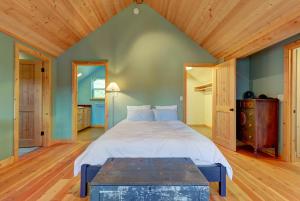 a bedroom with a large bed and a wooden ceiling at The Osprey Perch in Garfield