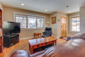 a living room with a couch and a flat screen tv at Durango Deluxe Townhome in Durango