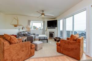 a living room with two couches and a fireplace at Harbor SeaShell in Lincoln City