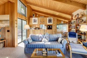 a living room with a blue couch and a table at Prentiss Retreat in Sea Ranch
