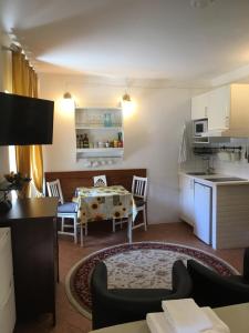 a living room with a table and a kitchen at M9 Pantheon Attic 10 in Rome