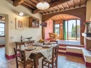 a kitchen and dining room with a table and chairs at Agriturismo Baccoleno in Asciano
