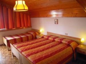 Postel nebo postele na pokoji v ubytování Miramonti Hotel