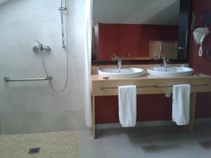 a bathroom with two sinks and a shower at The Cookbook Gastro Boutique Hotel & SPA in Calpe