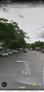 a street with cars parked in a parking lot at One Oasis 2BR beside SM City Mall upto 6pax in Davao City