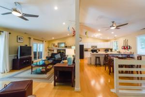 a living room and a kitchen with a ceiling fan at Home Away From Home in Ocean Pines