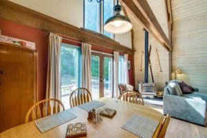 a dining room with a table with chairs and a couch at Nason Creek Cabin in Nason Creek