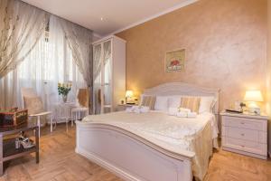 a bedroom with a large white bed and a table at Starry Rome Guest House in Rome