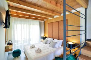 a bedroom with a bunk bed with a ladder at Elia Agia Marina Hotel in Agia Marina Nea Kydonias