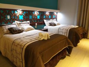 Postel nebo postele na pokoji v ubytování 9 Estrellas Casa Hotel