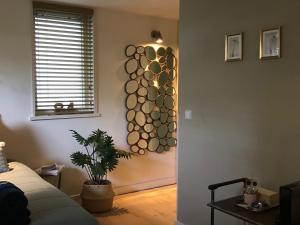 a bedroom with a wall with a circular wall art at 84huis in Amstelveen