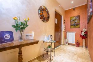 a room with a table and flowers on the wall at Starry Rome Guest House in Rome