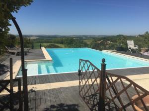 a view of a swimming pool from a house at Las Canéres in Castelnau-dʼArbieu