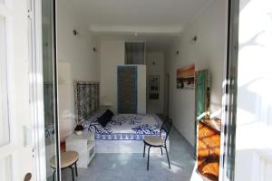 a small bedroom with a bed and two chairs at La Terrazza dei Sogni in Ustica