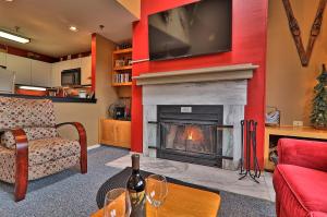 a living room with a fireplace with a tv above it at Cozy,1 bedroom loft condo! Ski back trails, shuttle& Sports center Highridge E11 in Killington