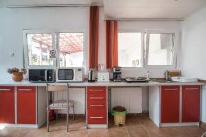 a kitchen with red cabinets and a counter top at Transylvania Guest House in Braşov