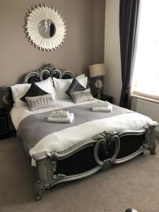 a bed with a white comforter and pillows at Washington House Hotel in Bournemouth