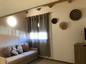 a living room with a couch and a window at Résidence Porto Marine in Porto Ota