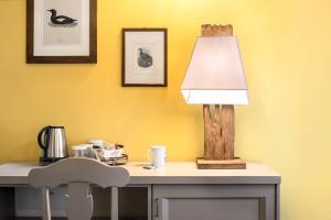 una lámpara en un escritorio con una mesa y una silla en Ca' Ciaran, en Chiarano