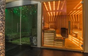 a room with a sliding glass door with a shower at Hotel Kostelski Buk in Bihać