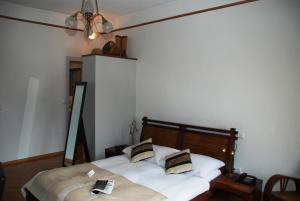 Letto o letti in una camera di Hostellerie de Genève