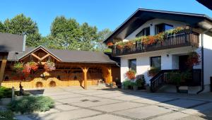 a house with flower boxes on the balconies at Garden Apartments Janša in Radovljica