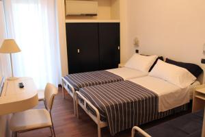 Postel nebo postele na pokoji v ubytování Hotel Nettuno