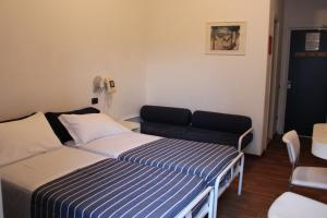 Postel nebo postele na pokoji v ubytování Hotel Nettuno