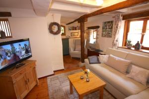 a living room with a couch and a flat screen tv at Ferienhaus am Marienkloster in Quedlinburg