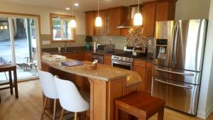 a kitchen with a stainless steel refrigerator and wooden cabinets at Water View Home in Seattle