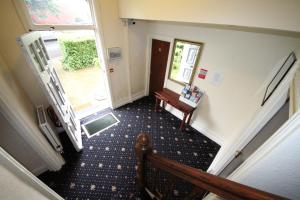 a living room with a door leading to a hallway at Avalon Guest House in Leeds