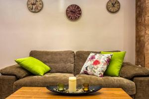 sala de estar con sofá y reloj en la pared en Luxury 2 bedroom,2 bathroom apart ,free parking en Plovdiv