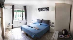 a bedroom with a blue bed and a mirror at Ostiense District B&B in Rome