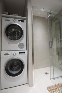 une laveuse et une sécheuse dans une pièce avec une porte vitrée dans l'établissement Excellent Appt 2 pièces Super Croisette, à Cannes 11 autres photos