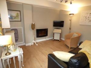 a living room with a couch and a fireplace at No6 @ Globe Lane,Alston in Alston