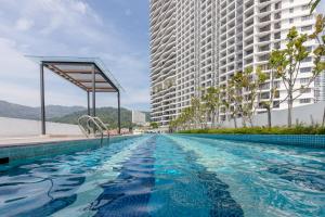 a swimming pool in front of two tall buildings at The Landmark Condo, by Sanguine in George Town