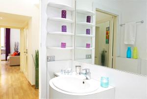 a white bathroom with a sink and a mirror at Fantasie in Trastevere in Rome +11 photos