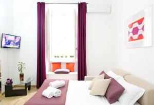 a bedroom with a white bed with purple curtains at Fantasie in Trastevere in Rome