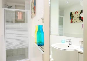 a bathroom with a sink and a blue vase at Fantasie in Trastevere in Rome