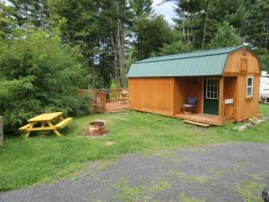 a wooden cabin with a picnic table and a picnic table at Villa Marie in East Durham