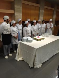 a group of chefs standing around a table with a cake at Casa de Vacanta Saru Dornei in Şarul Dornei