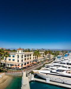 a marina filled with lots of boats next to a city at Balboa Bay Resort in Newport Beach