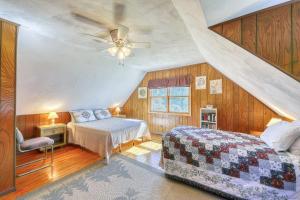 a bedroom with two beds and a ceiling fan at Adirondack Adventuring in Brant Lake