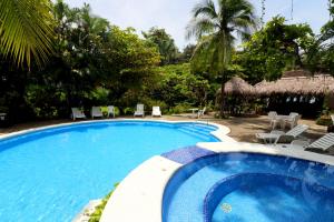 
a beach with a pool and a pool table at Karahe Beach Hotel in Manuel Antonio
